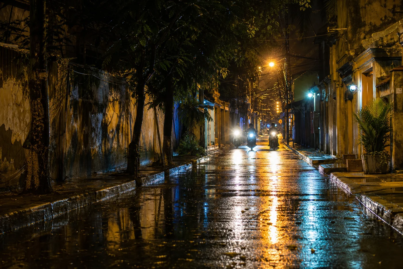 Rainy tropical Thai street at night with warm street lights reflecting in puddles and motorbike headlights in the distance, atmospheric monsoon scene